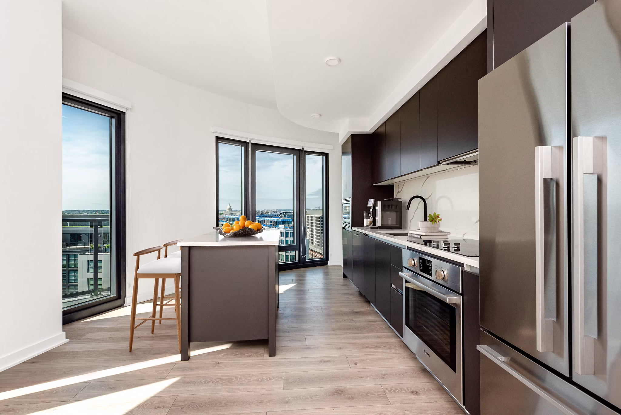 Modern kitchen with sleek countertops and stainless steel appliances at The Gantry Apartments