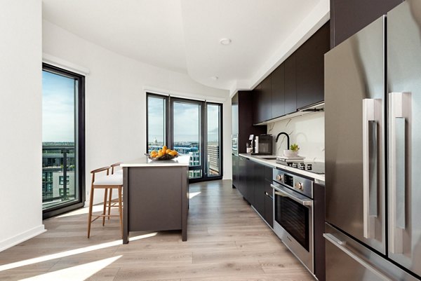 Modern kitchen with sleek countertops and stainless steel appliances at The Gantry Apartments
