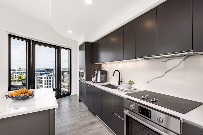 Modern kitchen with stainless steel appliances at The Gantry Apartments