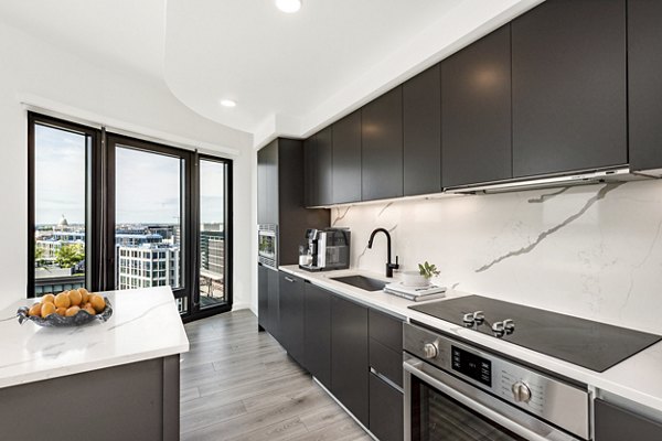 Modern kitchen with stainless steel appliances at The Gantry Apartments