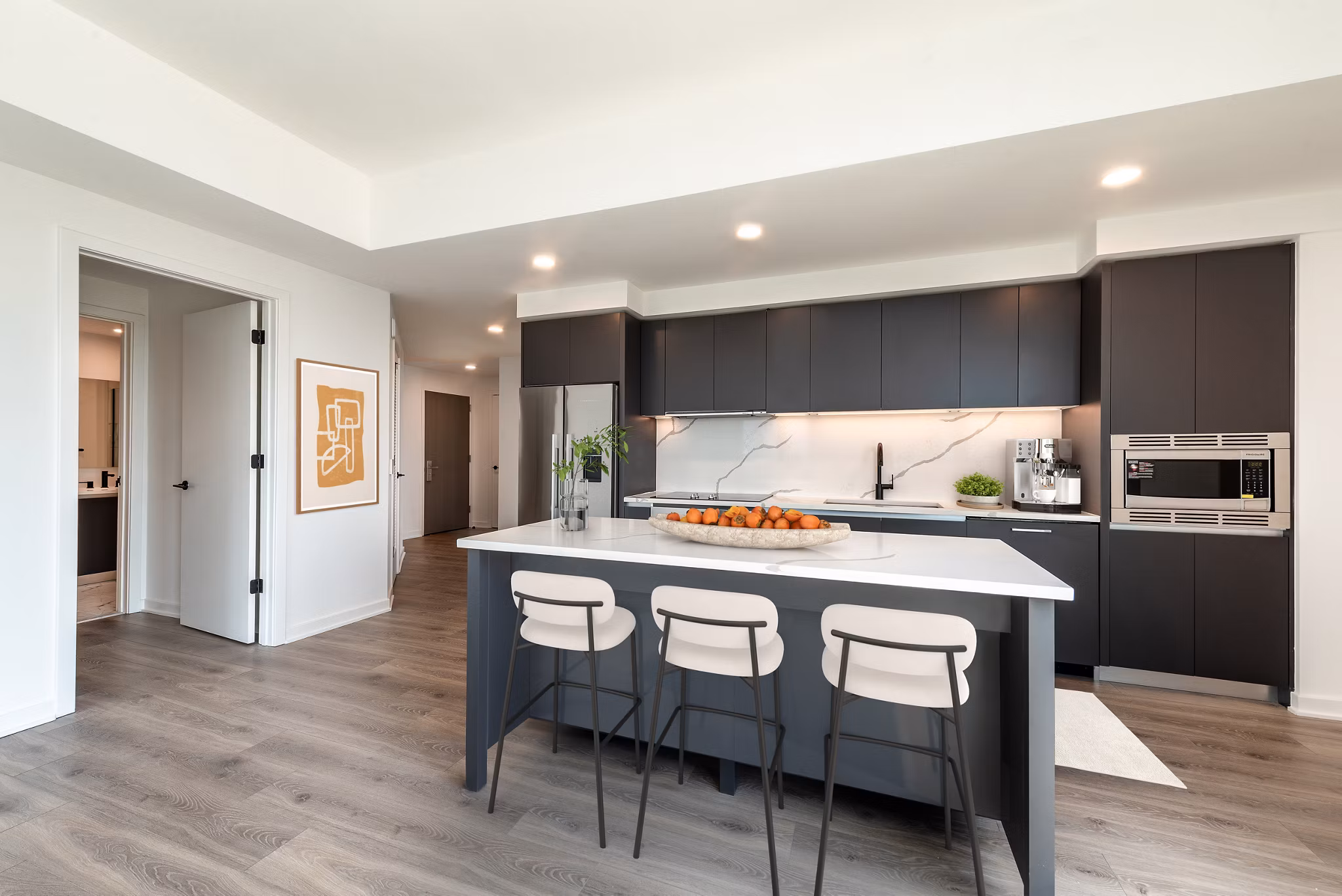 Modern kitchen with sleek appliances and island in The Gantry Apartments