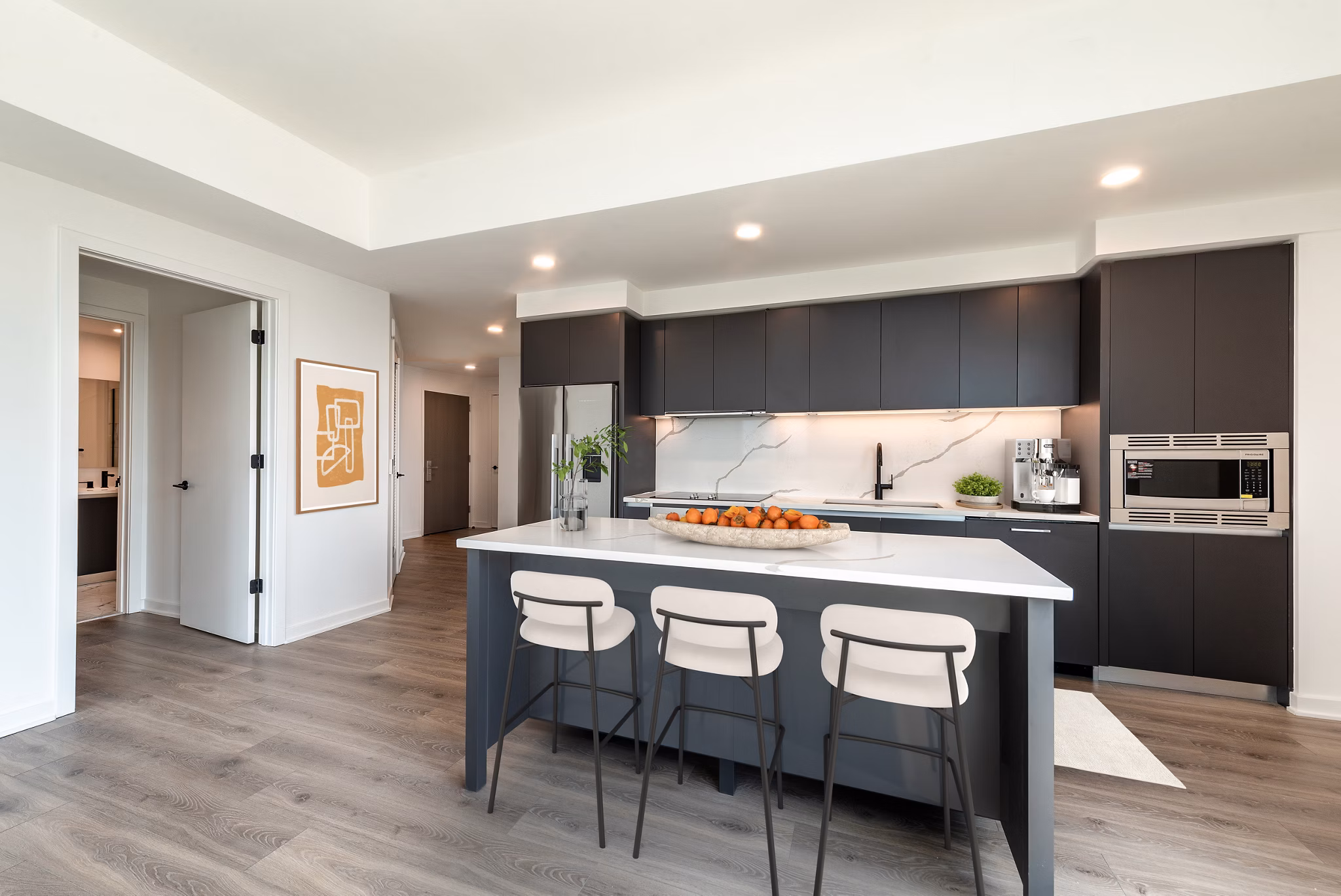Modern kitchen with sleek appliances and island in The Gantry Apartments