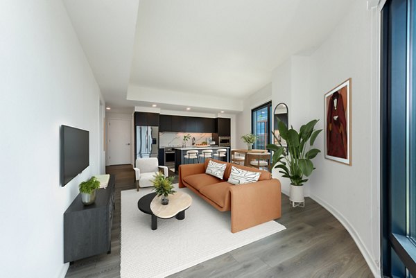 Spacious living room with modern decor and large windows at The Gantry Apartments in sunny location, ideal for luxury living