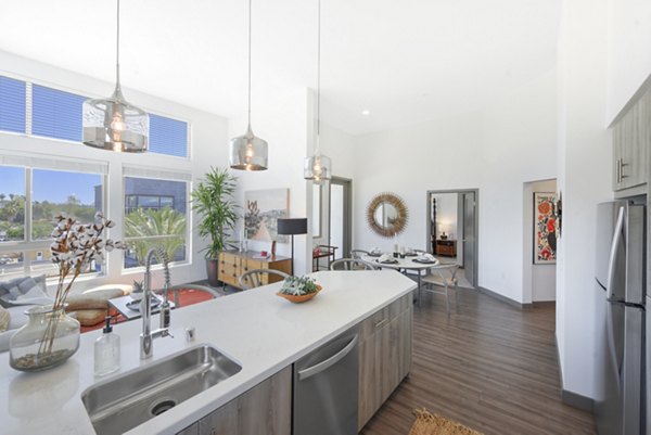 Modern kitchen featuring stainless appliances and granite countertops at Persea Apartments luxury living community