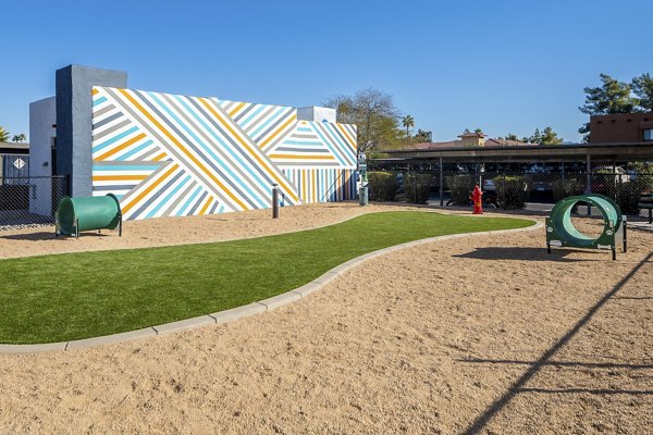 Dog park with agility equipment at Vida46 Apartments