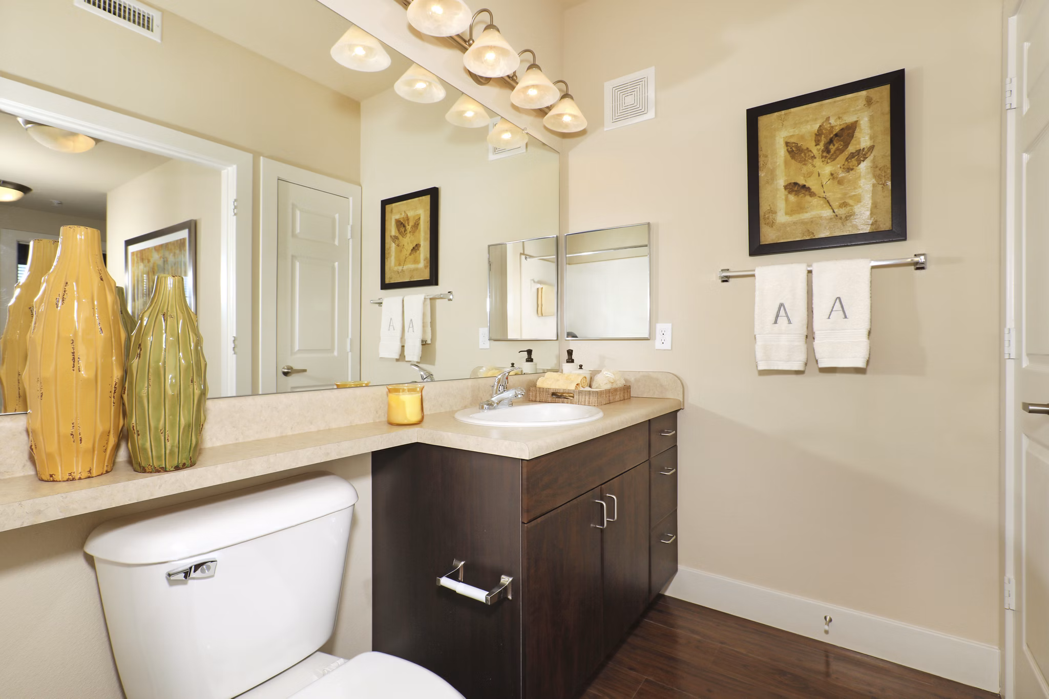 Modern bathroom with sleek finishes at Arvada Station Apartments featuring a spacious vanity and elegant lighting