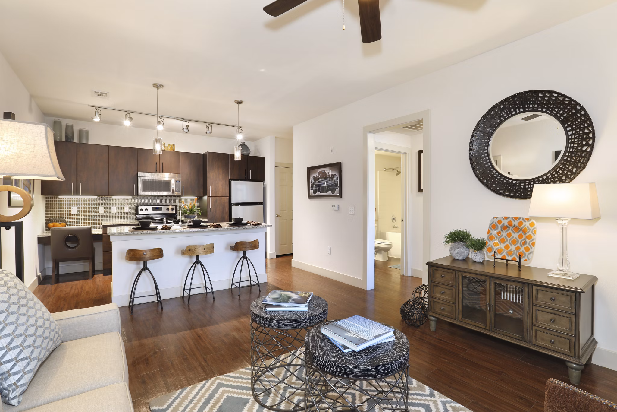 Spacious living room with modern dÃ©cor and large windows in Arvada Station Apartments