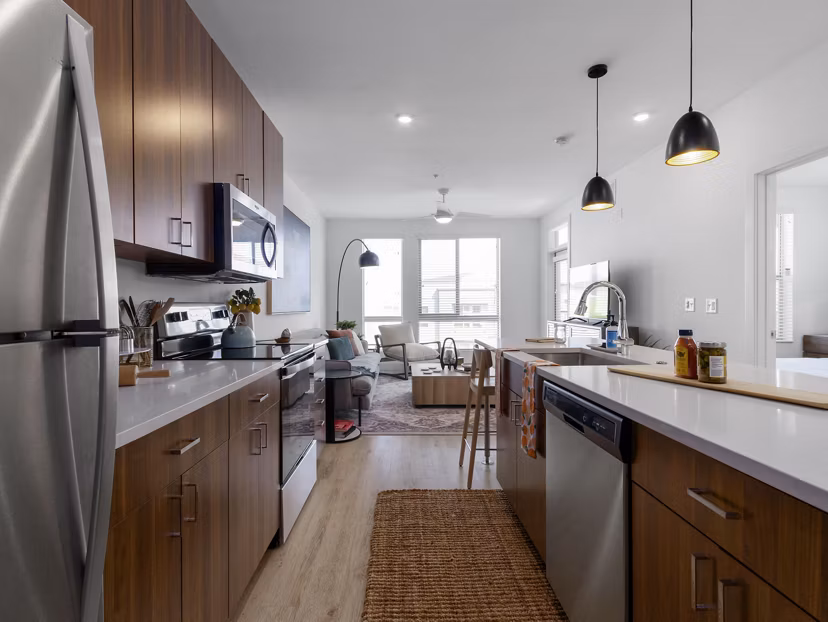 Modern kitchen with stainless steel appliances at Upper West Apartments