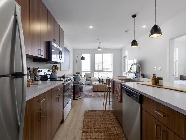 Modern kitchen with stainless steel appliances at Upper West Apartments