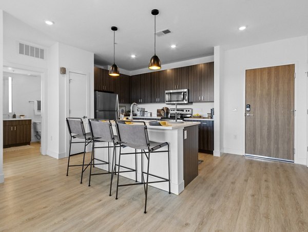 Modern kitchen with sleek countertops and stainless steel appliances at Upper West Apartments in a vibrant urban setting