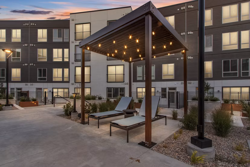Serene courtyard featuring lush greenery and seating at Upper West Apartments