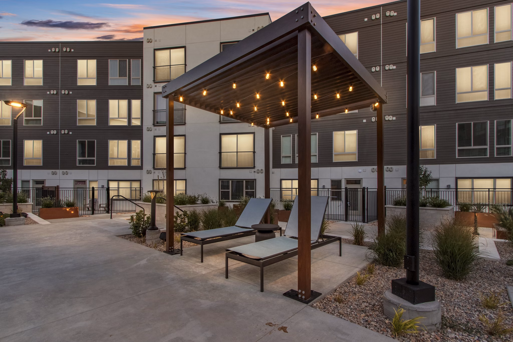 Serene courtyard featuring lush greenery and seating at Upper West Apartments