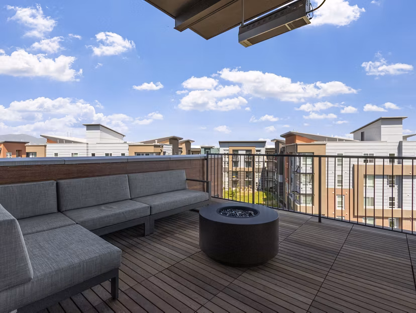 Cozy fire pit lounge area at Upper West Apartments, perfect for relaxation and social gatherings in a modern luxury setting