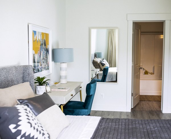 Cozy bedroom with modern decor at Mirella at Foxboro Apartments: Luxury living in Greystar's upscale community