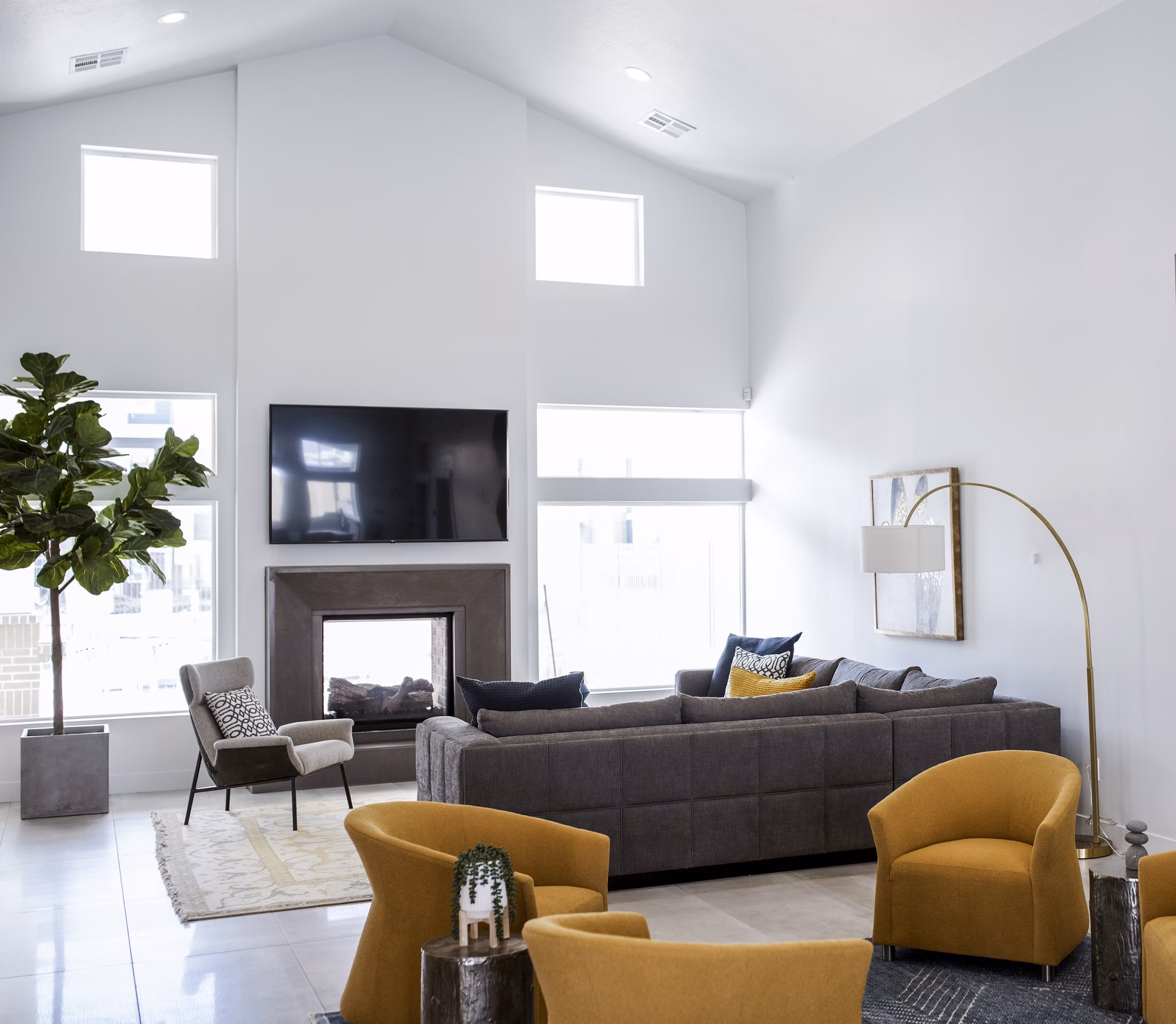 Clubhouse with contemporary decor at Mirella at Foxboro Apartments, featuring modern seating and elegant lighting