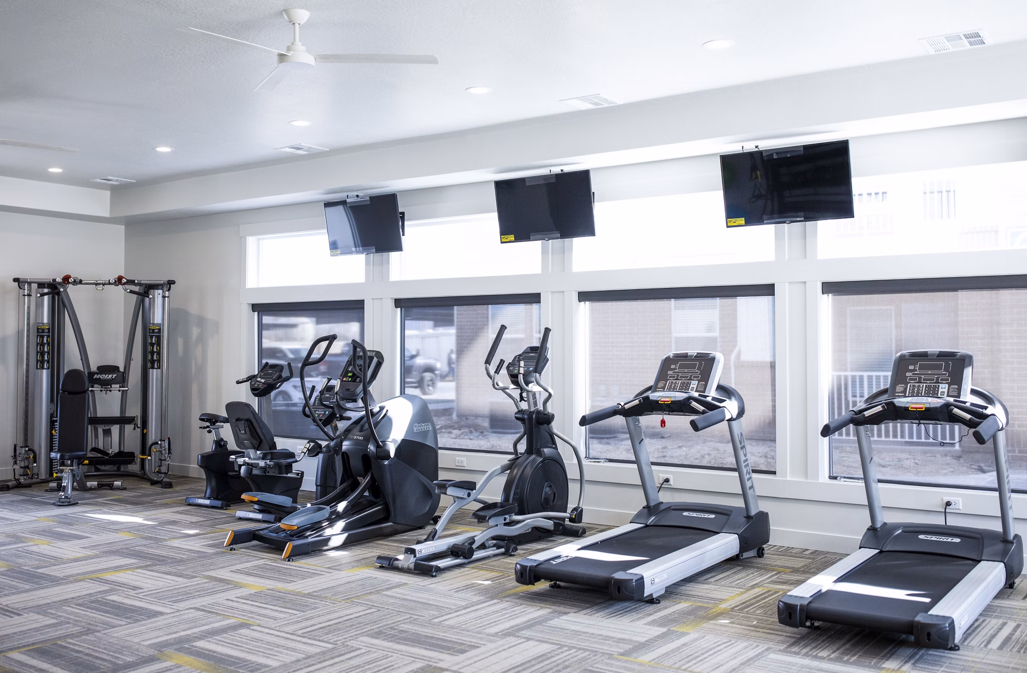State-of-the-art fitness center at Mirella at Foxboro Apartments featuring modern equipment and spacious workout areas