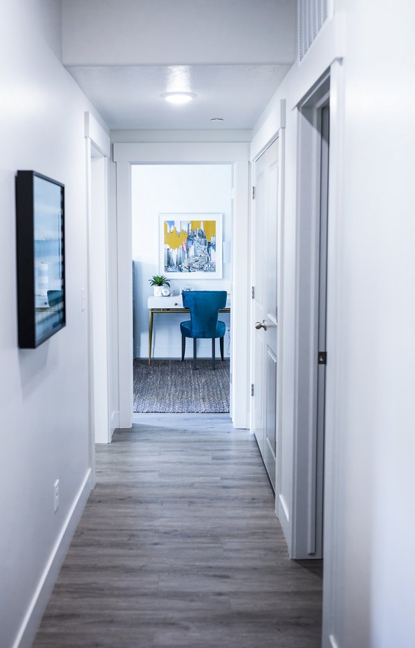 Hallway featuring contemporary design and modern lighting at Mirella at Foxboro Apartments, a Greystar luxury residence