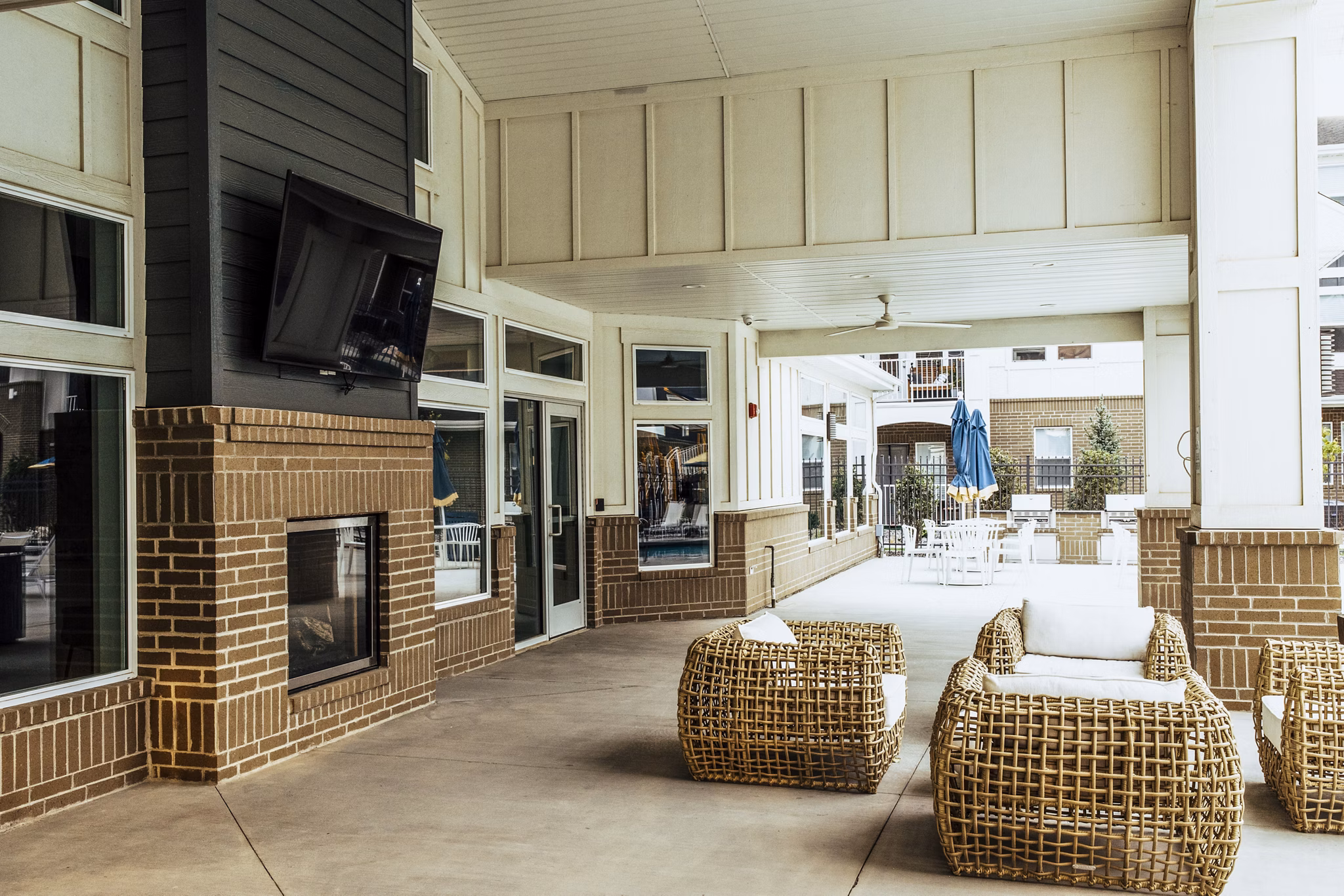 Mirella at Foxboro Apartments: Cozy patio with fireplace providing luxury living experience