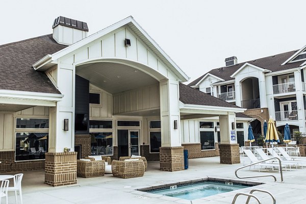 Cozy outdoor patio with fireplace at Mirella at Foxboro Apartments