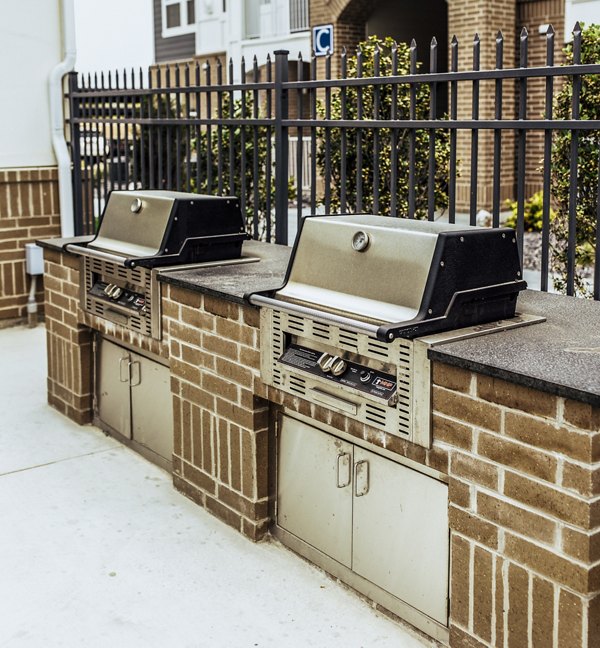 Grill area with modern seating at Mirella at Foxboro Apartments, perfect for outdoor dining and entertaining