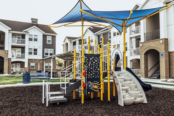 Playground at Mirella at Foxboro Apartments featuring modern play structures for families and residents