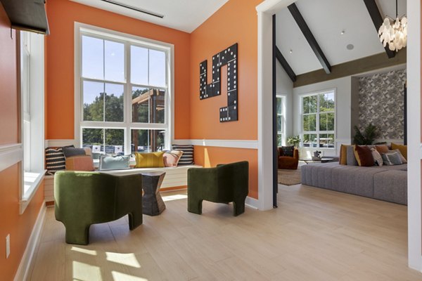 Clubhouse with modern lounge seating and entertainment area at Broadstone Ayrsley Apartments, a Greystar luxury property