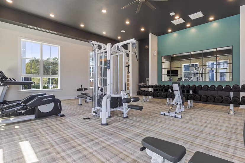 Well-equipped fitness center at Broadstone Ayrsley Apartments offering modern exercise machines and spacious workout areas