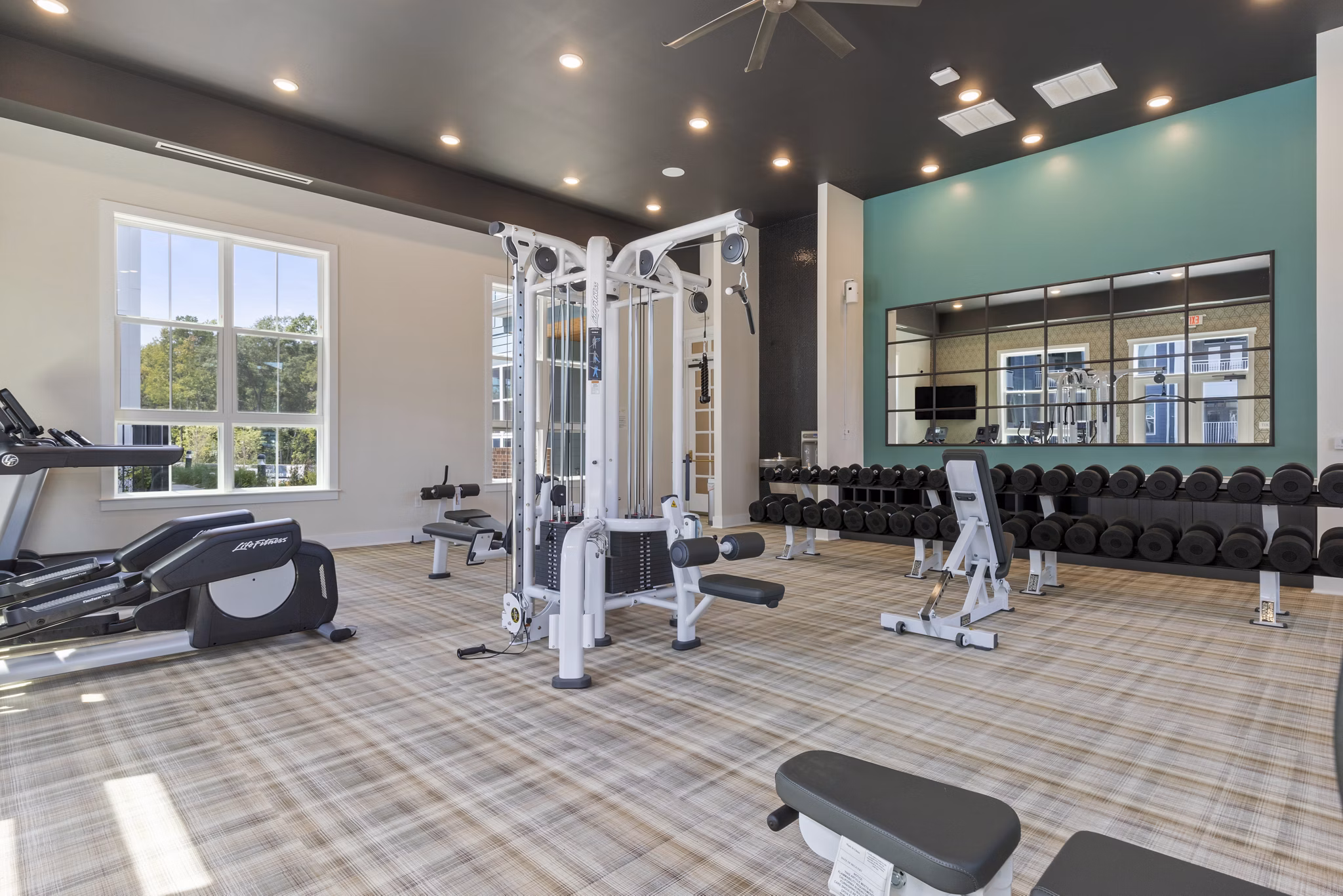 Well-equipped fitness center at Broadstone Ayrsley Apartments offering modern exercise machines and spacious workout areas