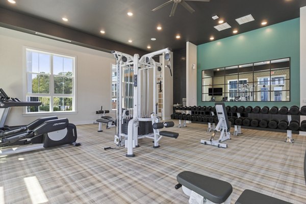 Well-equipped fitness center at Broadstone Ayrsley Apartments offering modern exercise machines and spacious workout areas