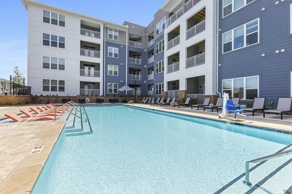 Resort-style pool with lounge chairs at Broadstone Ayrsley Apartments, luxury living with premium amenities in Charlotte