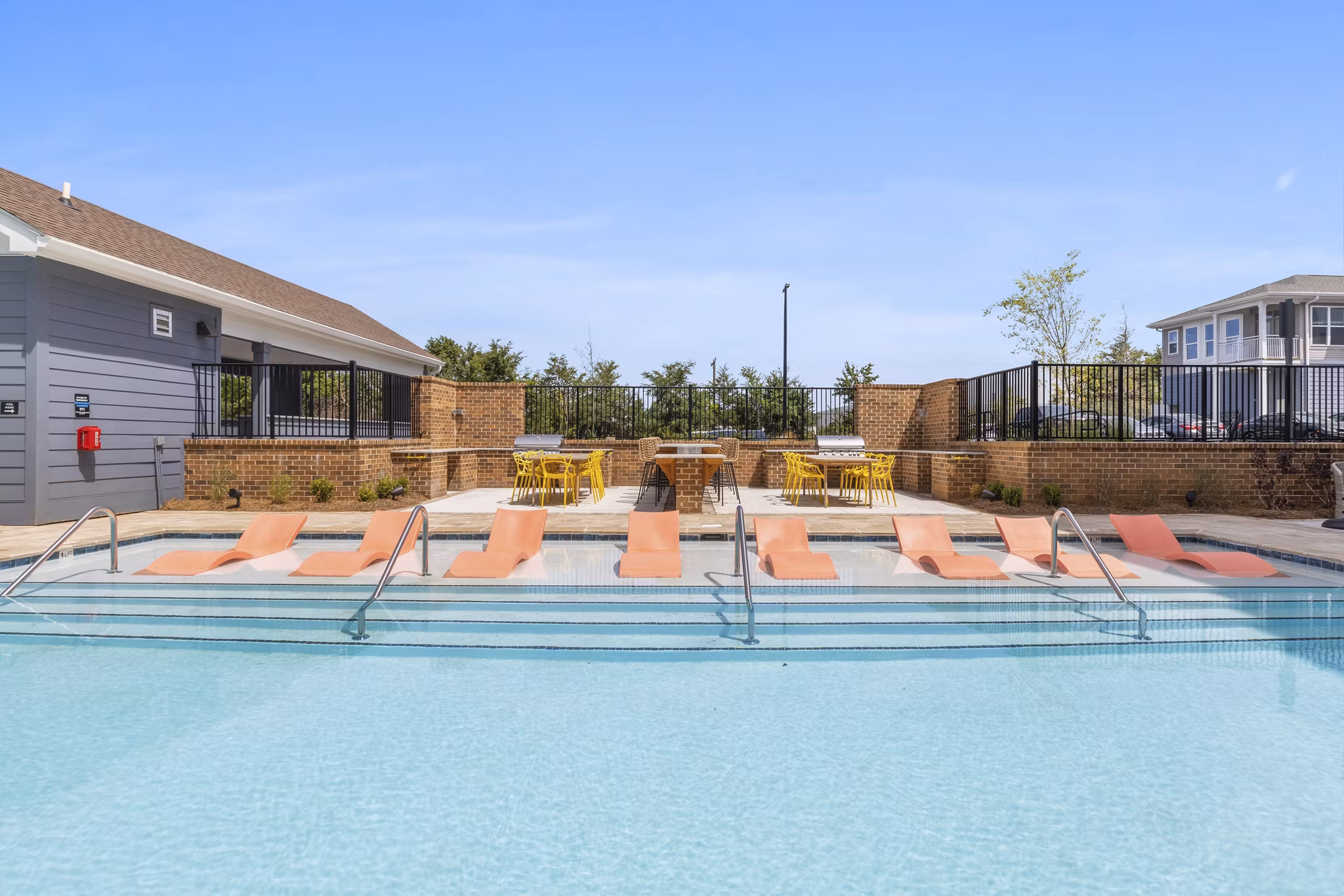 Resort-style pool area with sun loungers at Broadstone Ayrsley Apartments, offering luxury living in the heart of Charlotte