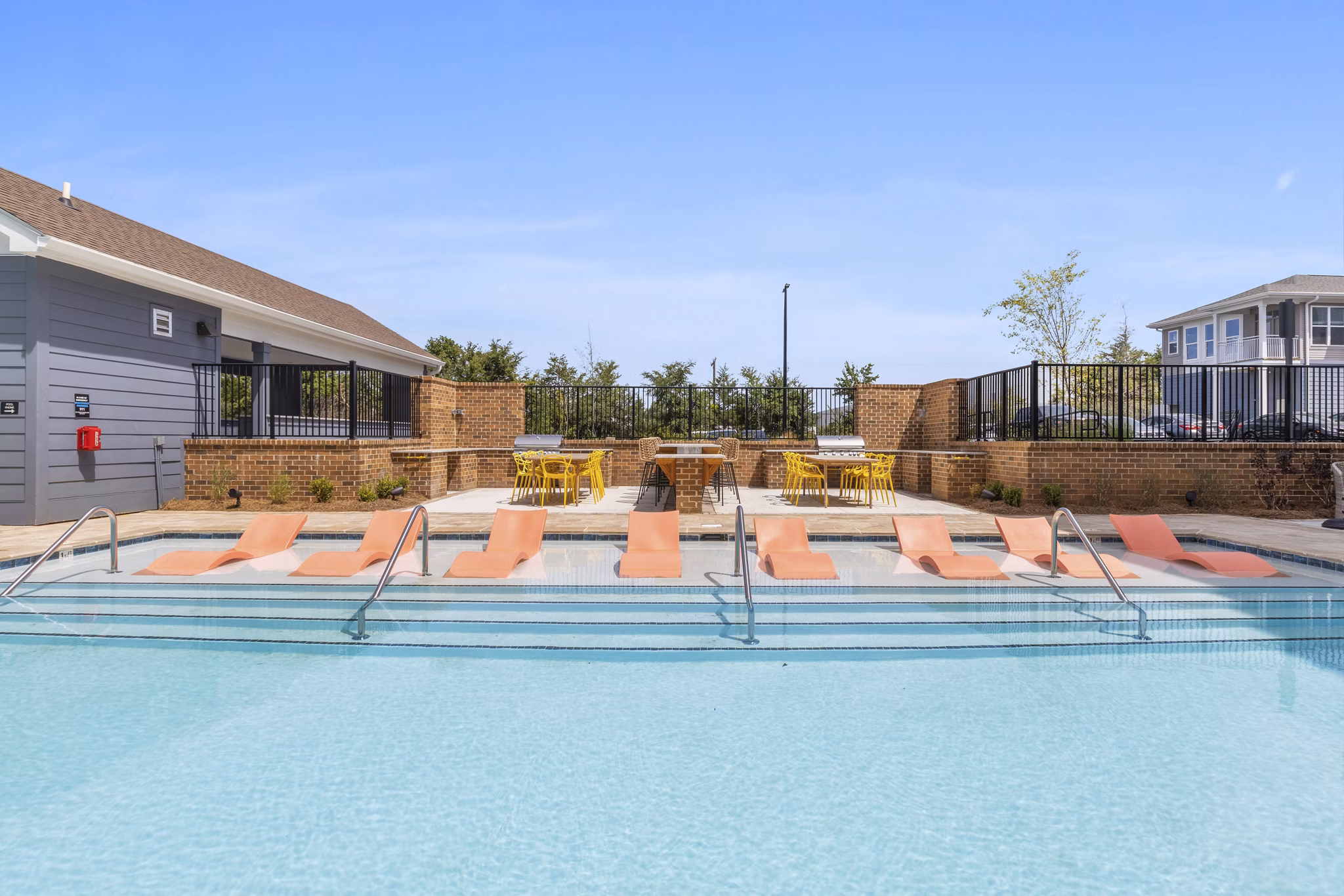 Resort-style pool area with sun loungers at Broadstone Ayrsley Apartments, offering luxury living in the heart of Charlotte