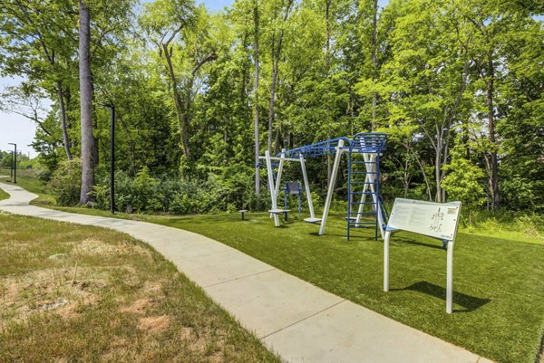 Playground featuring colorful equipment at Broadstone Ayrsley Apartments, offering family-friendly luxury living in a vibrant community