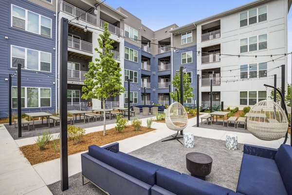 Recreational area with versatile seating and lush greenery at Broadstone Ayrsley Apartments in Charlotte