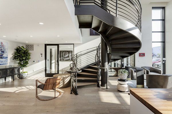 Contemporary clubhouse with modern seating and open workspace at Prado West Apartments