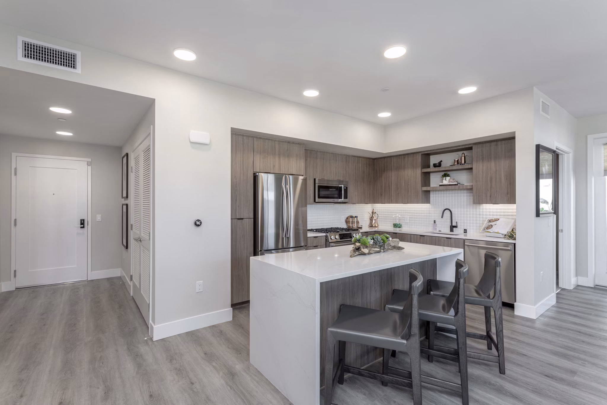Modern kitchen with stainless steel appliances at Prado West Apartments