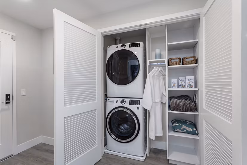 Spacious laundry room with modern appliances at Prado West Apartments in vibrant downtown setting