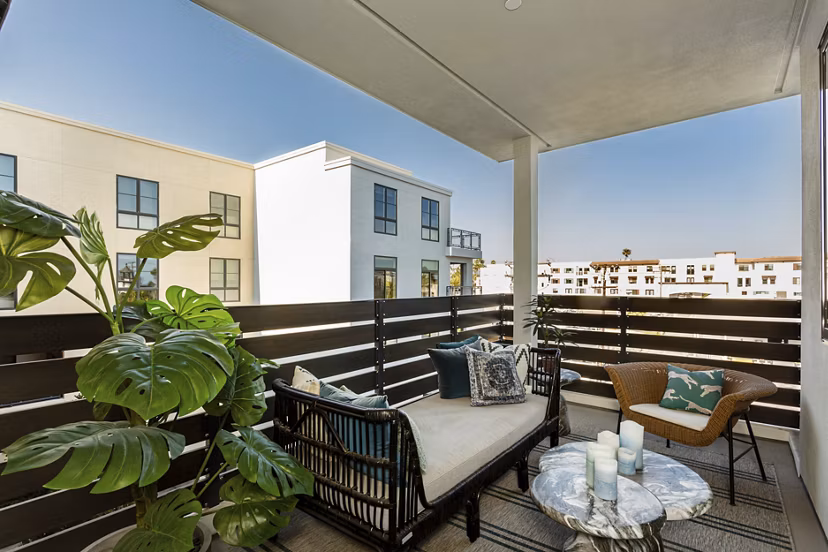 Prado West Apartments: Modern patio with stylish outdoor seating and lush greenery