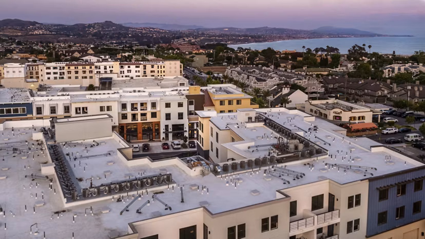Skyline view from rooftop at Prado West Apartments: Luxury high-rise living with stunning cityscape views