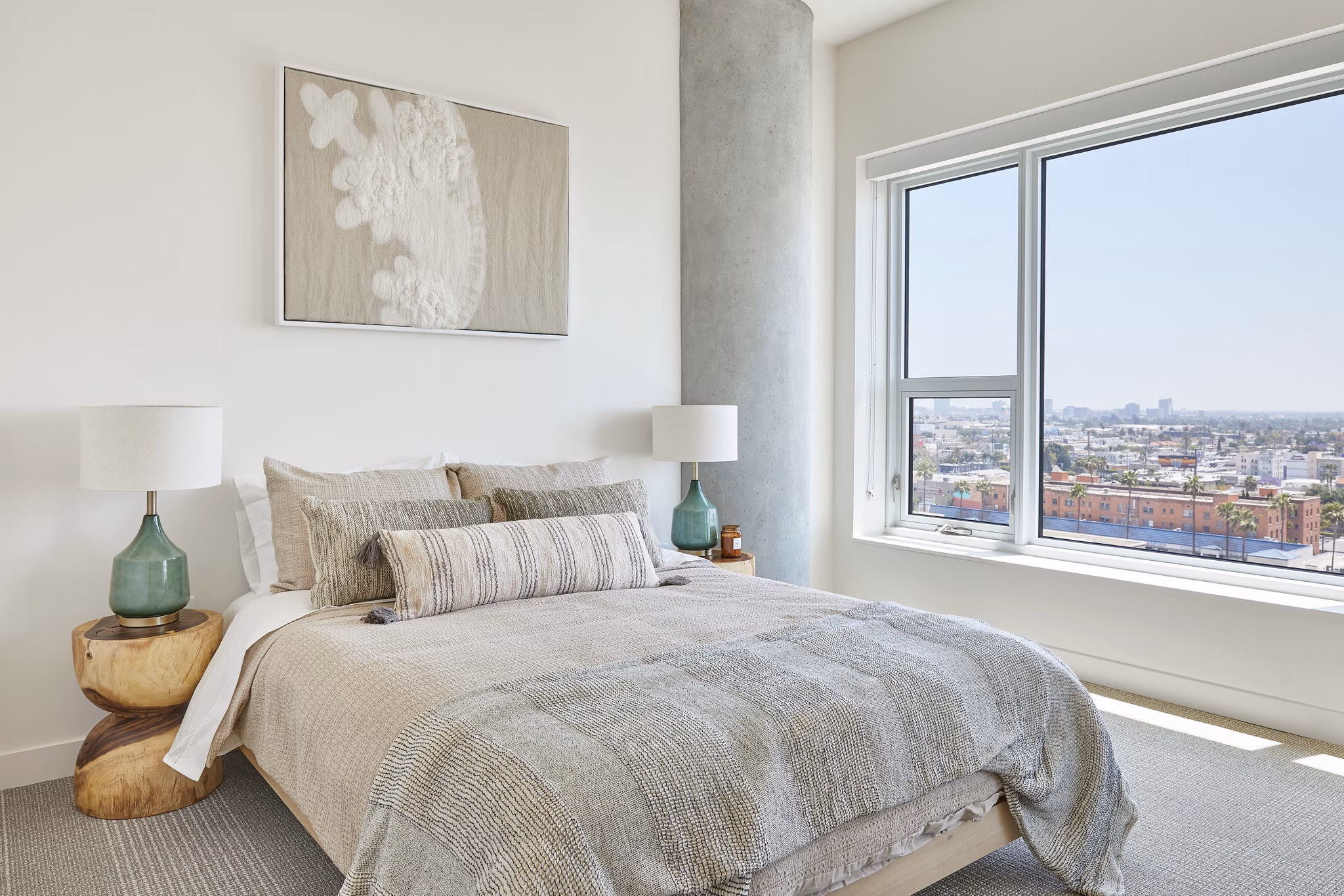 Cozy bedroom with modern furnishings at Jardine Apartments, offering luxury living by Greystar