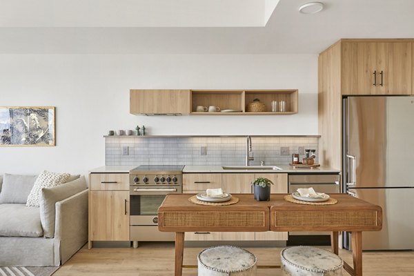 Sleek modern kitchen with stainless steel appliances at Jardine Apartments, luxury living spaces for discerning residents