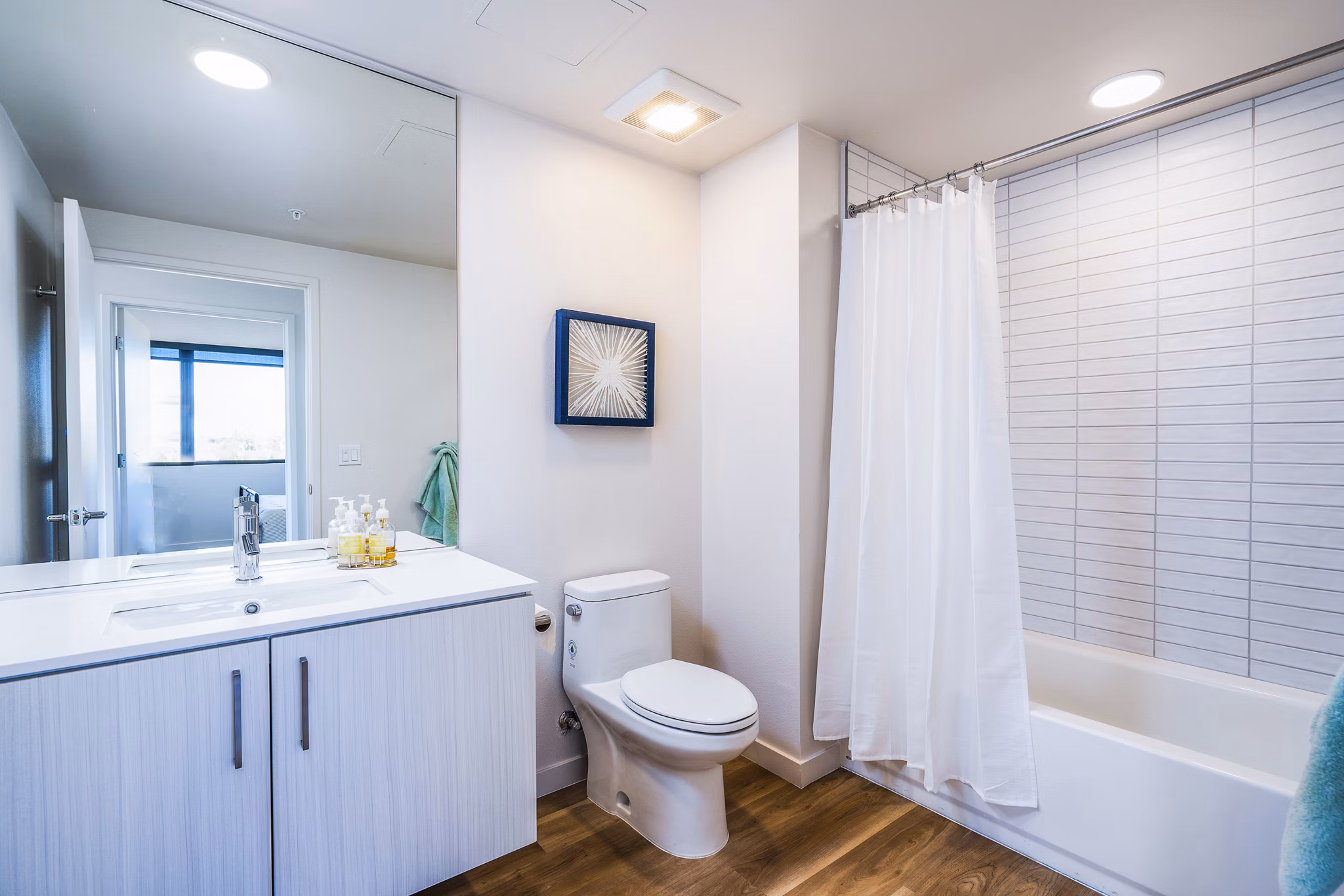 Modern bathroom with sleek fixtures at Exhibit at J Town Apartments, featuring spacious layout and luxurious amenities