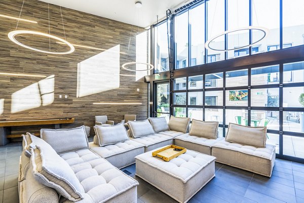 Clubhouse lobby featuring modern decor and seating at Exhibit at J Town Apartments