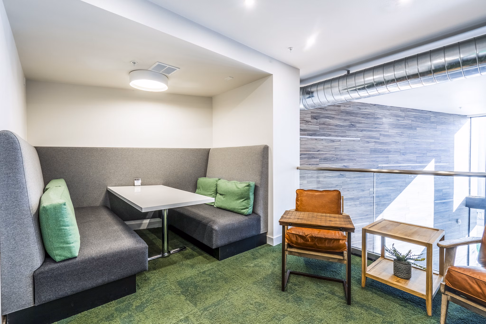 Inviting clubhouse lobby at Exhibit at J Town Apartments with modern seating and ambient lighting, offering a welcoming space for residents