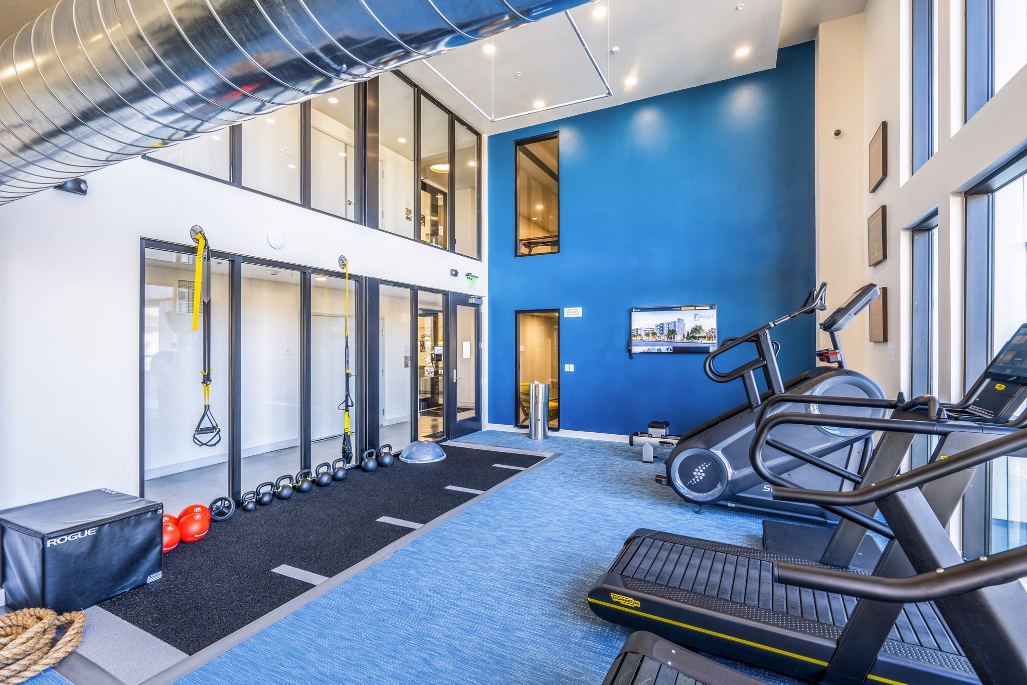 State-of-the-art fitness center with modern equipment at Exhibit at J Town Apartments