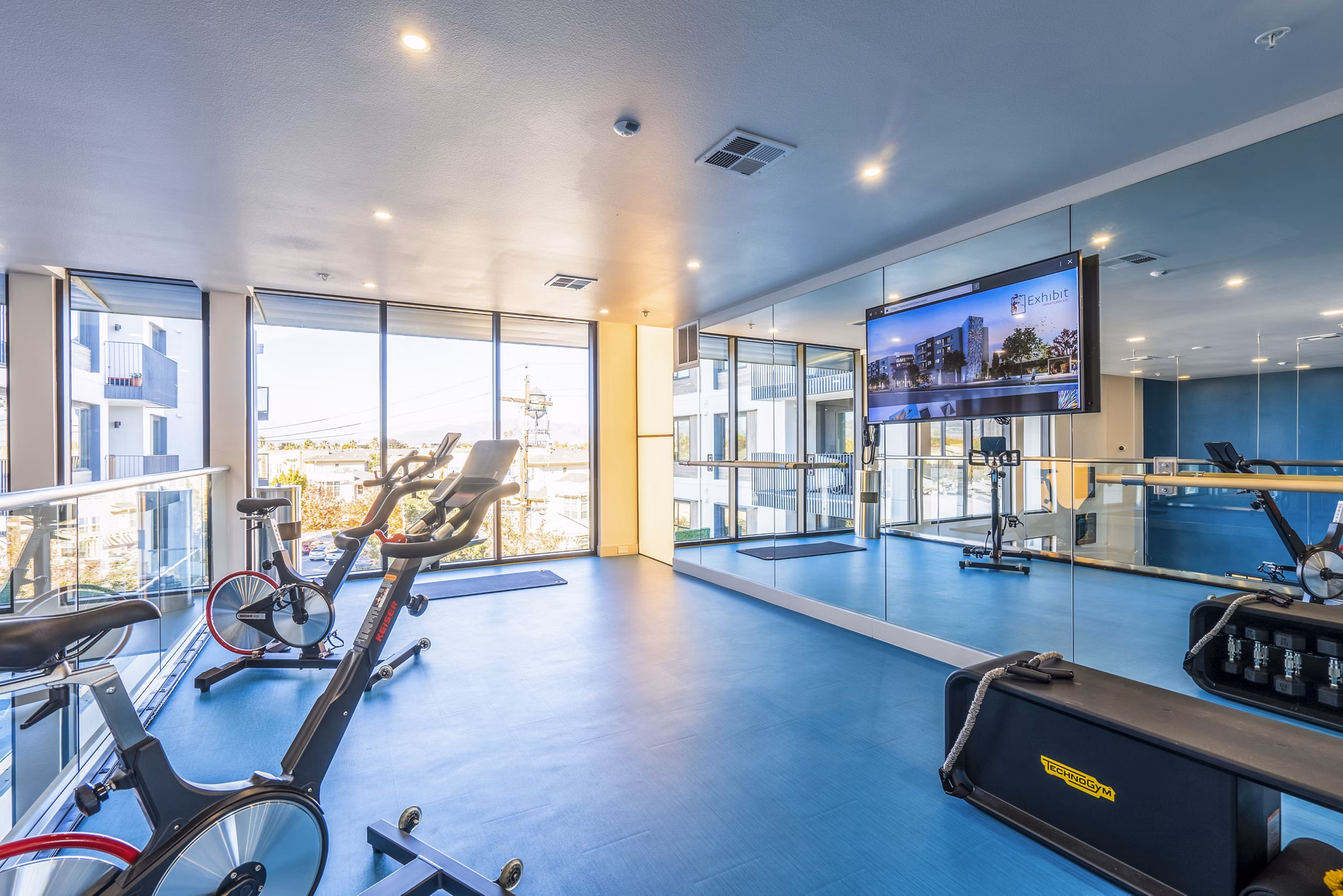 Exhibit at J Town Apartments: State-of-the-art fitness center with modern equipment and spacious layout for luxury living