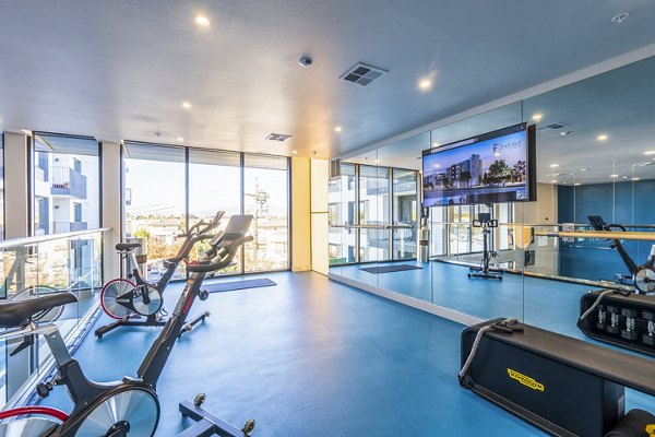 Exhibit at J Town Apartments: State-of-the-art fitness center with modern equipment and spacious layout for luxury living