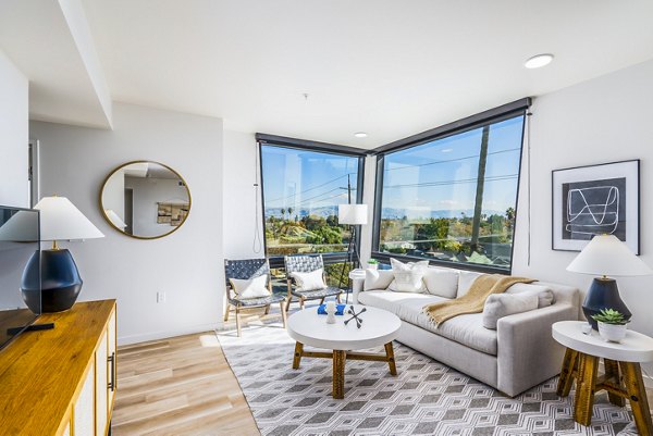 Spacious living room with modern furnishings at Exhibit at J Town Apartments