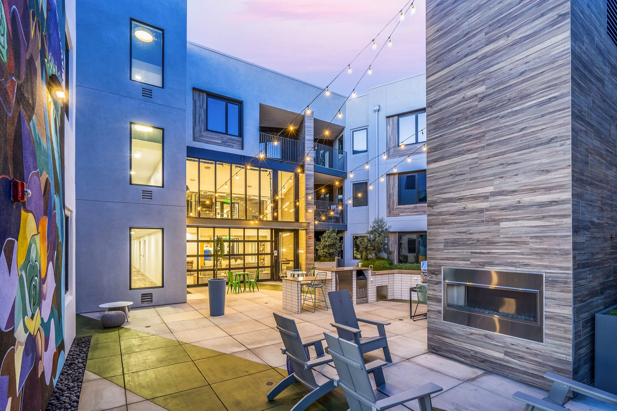 Grill and patio area with seating at Exhibit at J Town Apartmentsâ€”perfect for outdoor dining and relaxation