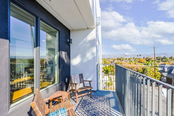 Chic patio with modern furnishings and skyline view at Exhibit at J Town Apartments